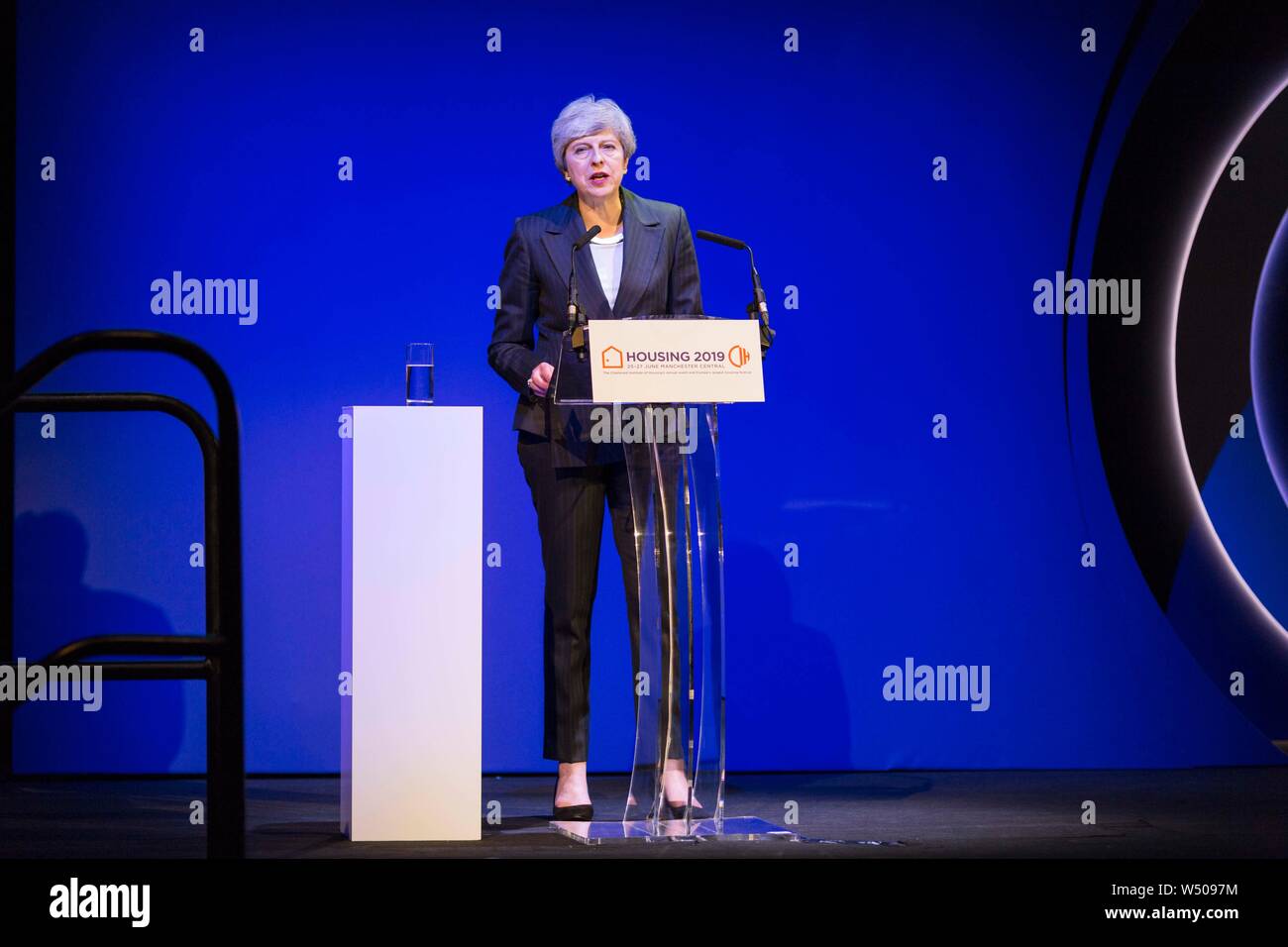 Prime Minister Theresa May on stage delivering her speech to the CIH conference in one of her last appearances as Prime Minister Stock Photo