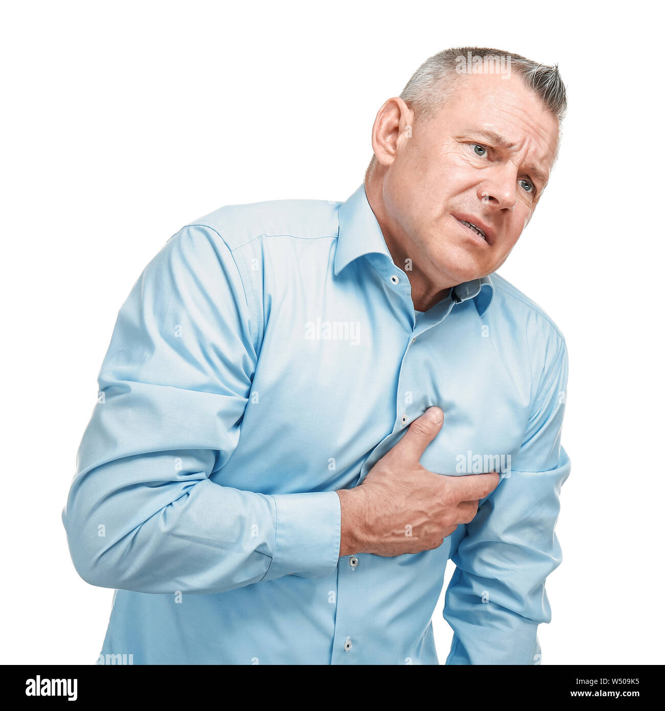 Handsome middle-aged man having heart attack on white background Stock Photo