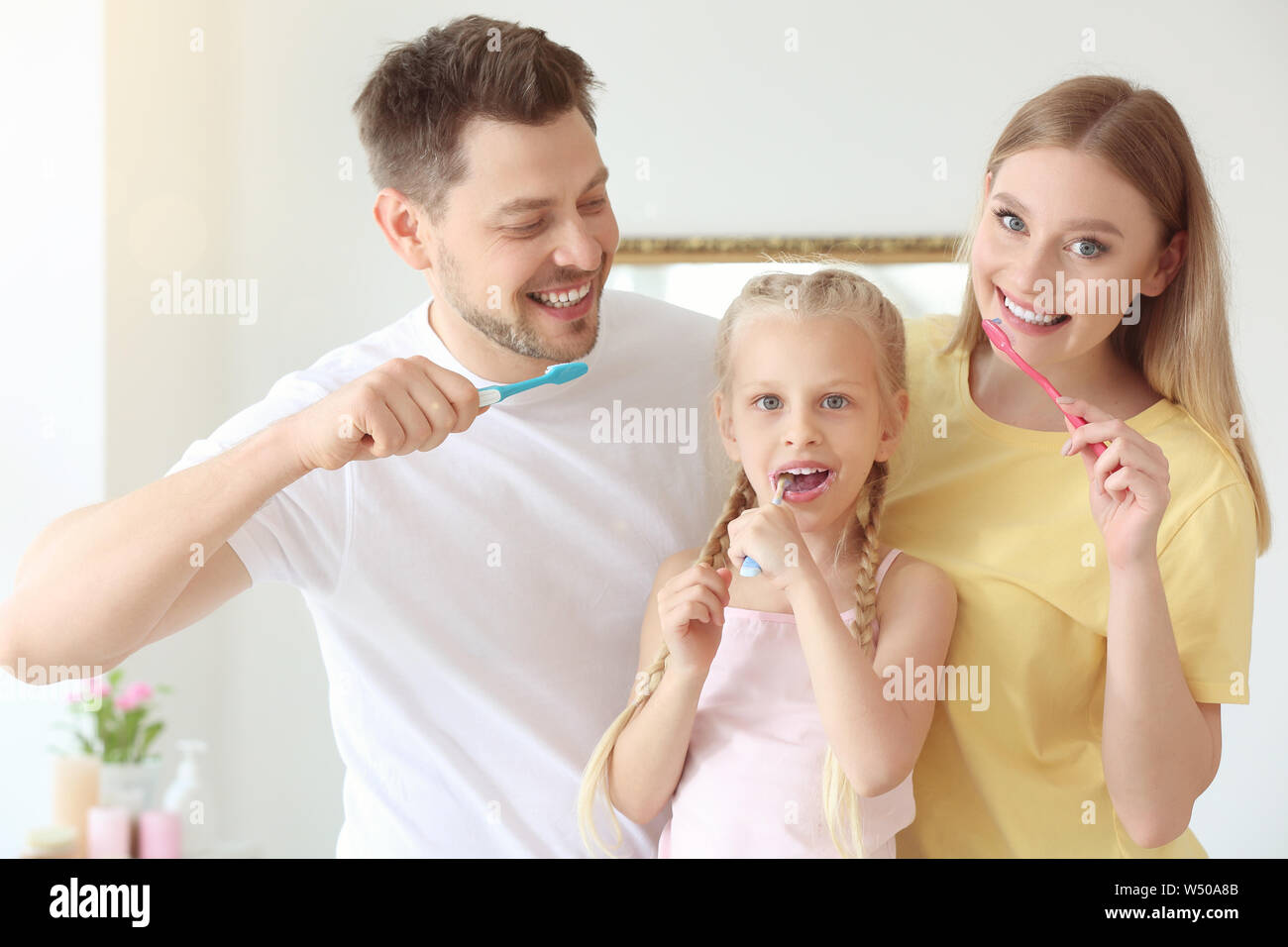 Family cleaning teeth at home Stock Photo Alamy
