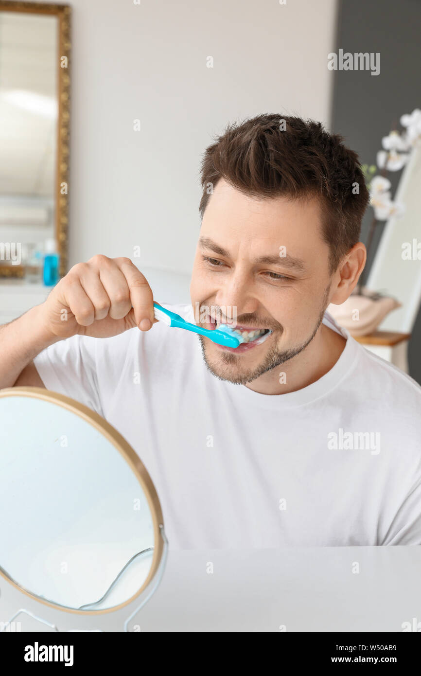 Man cleaning teeth at home Stock Photo Alamy