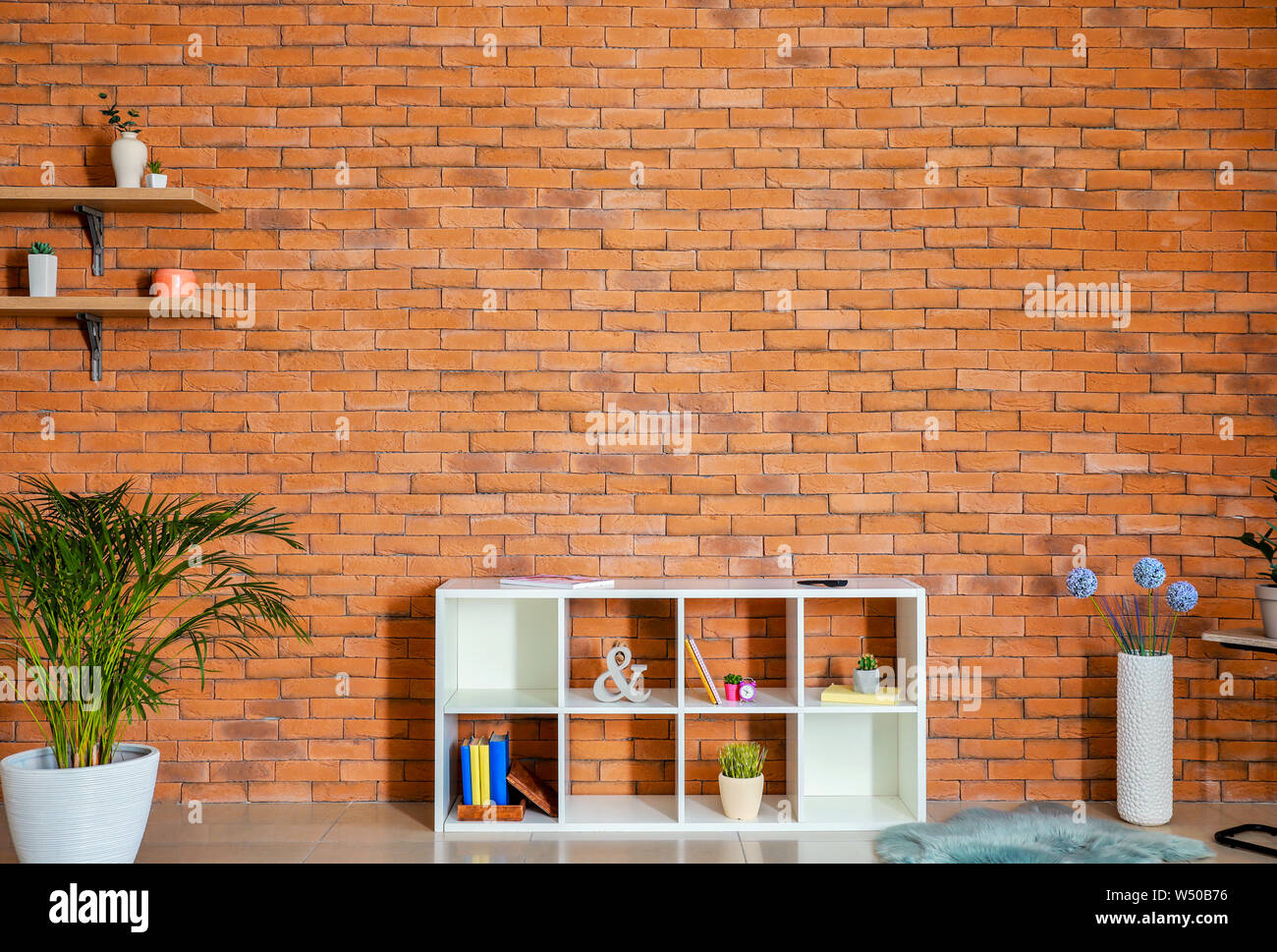 Stylish interior of modern living room with brick wall Stock Photo - Alamy