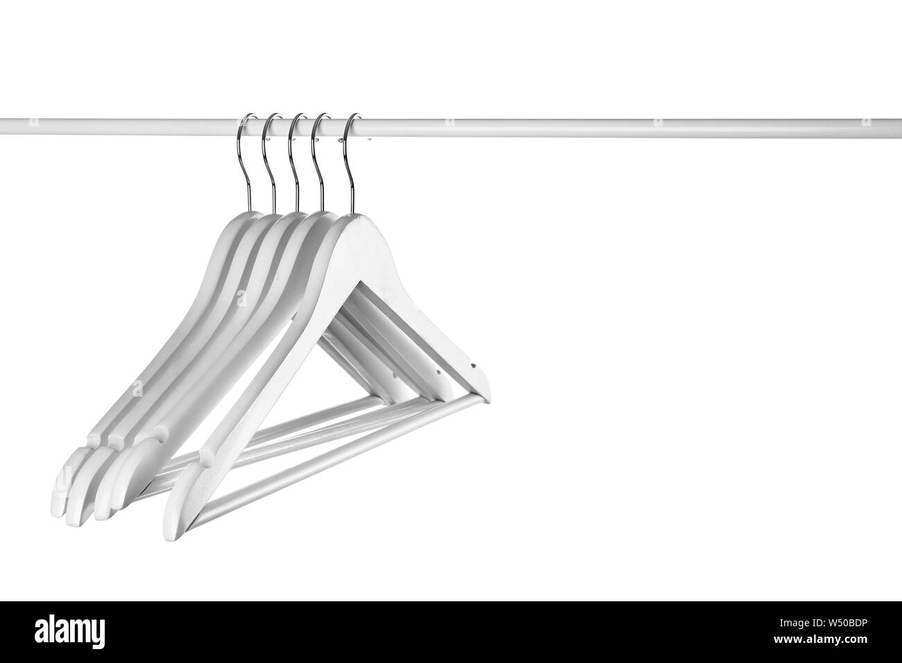 Rack with clothes hangers on white background Stock Photo - Alamy