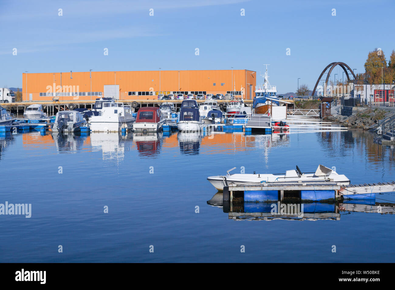 Boats moored in small Norwegian town at sunny autumn day. Levanger, Norway Stock Photo