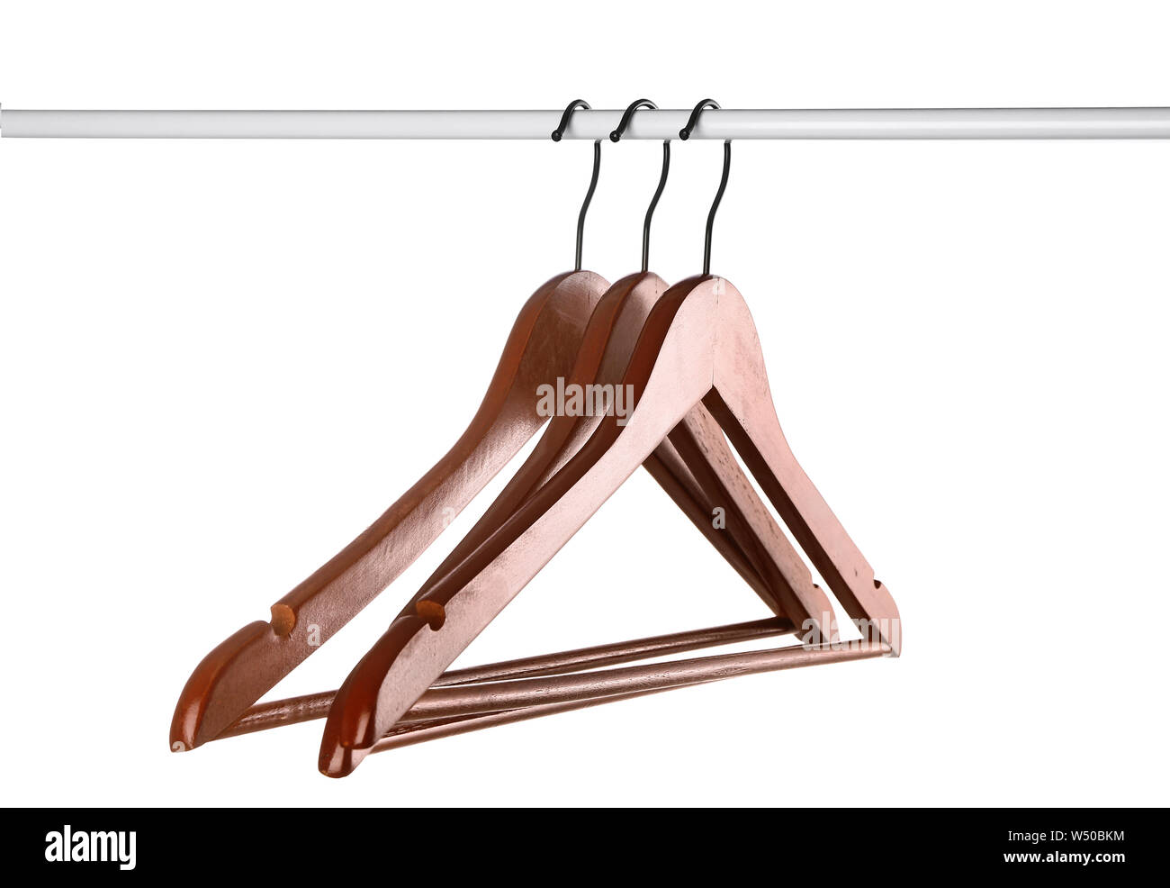 Rack with clothes hangers on white background Stock Photo - Alamy