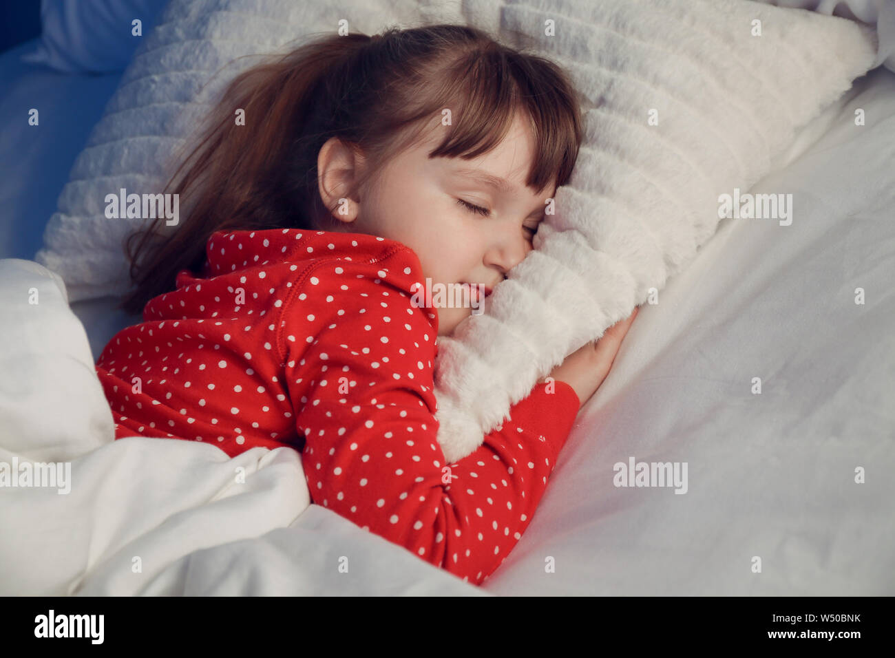 Cute little girl sleeping in bed at night Stock Photo Alamy