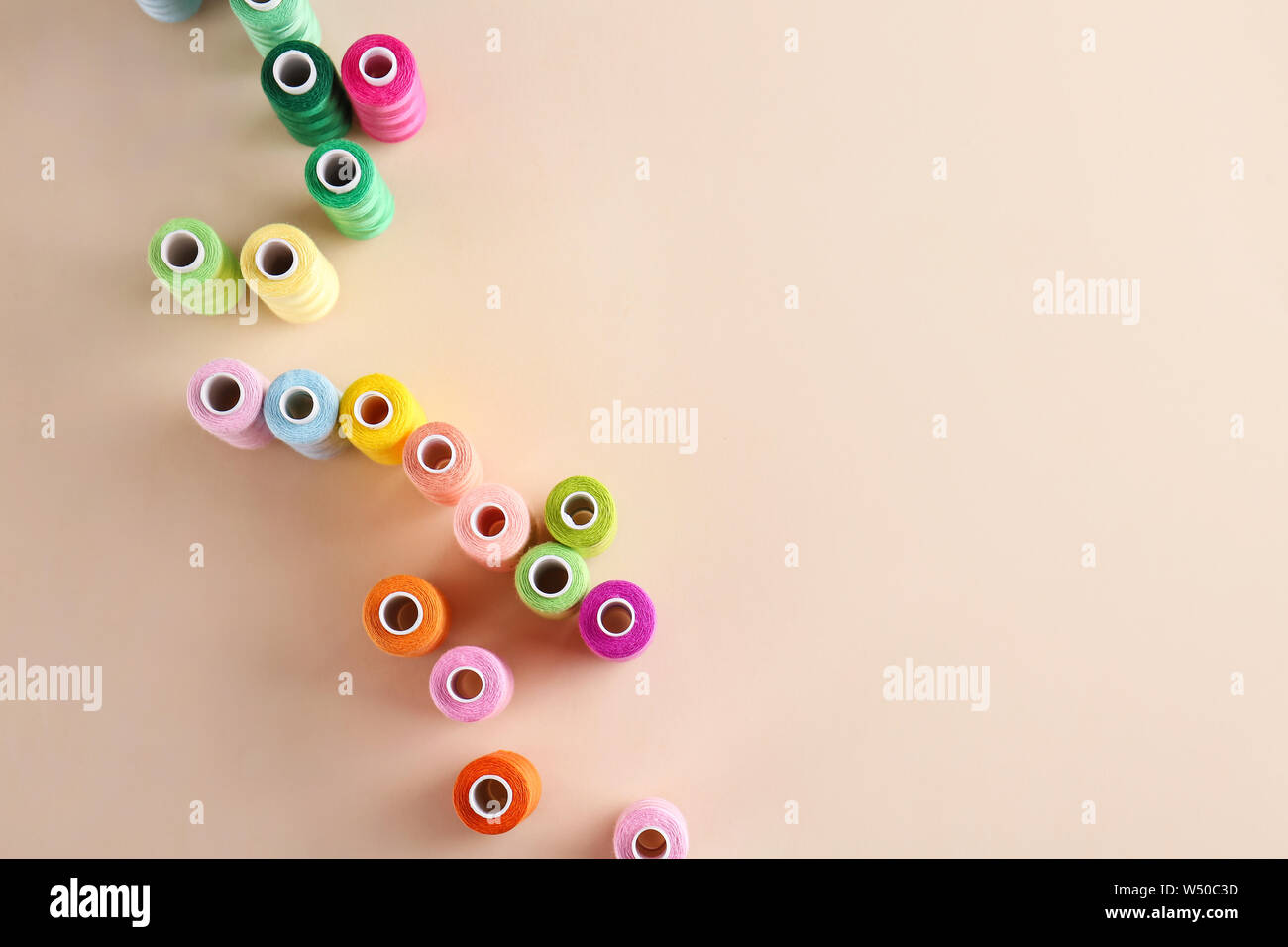 Many sewing threads on color background Stock Photo