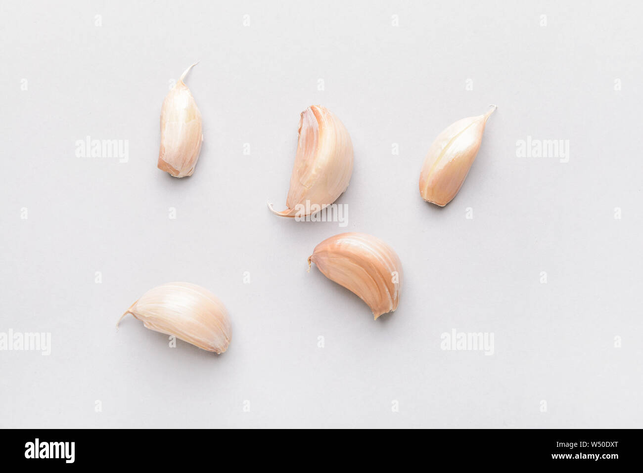 Garlic cloves on light background Stock Photo - Alamy