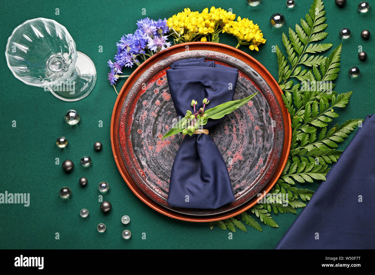 Beautiful table setting with floral decor on color background Stock Photo