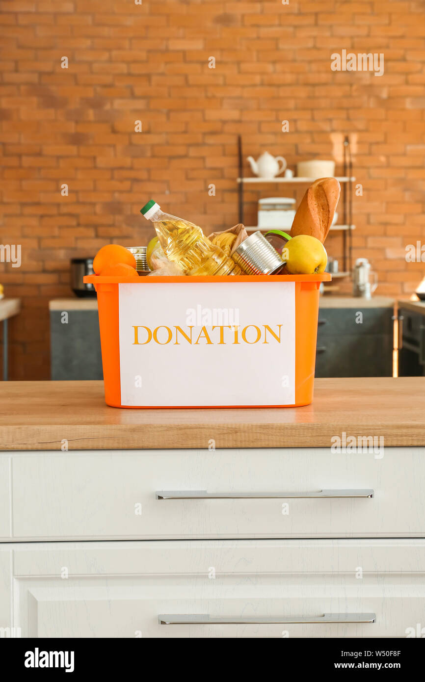 Box with donation food on table in kitchen Stock Photo Alamy