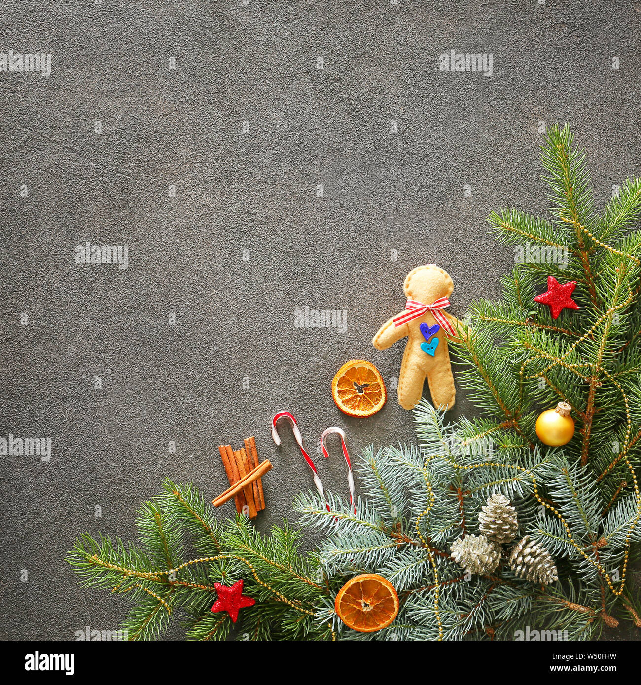 Christmas tree branches and decor on grey background Stock Photo - Alamy