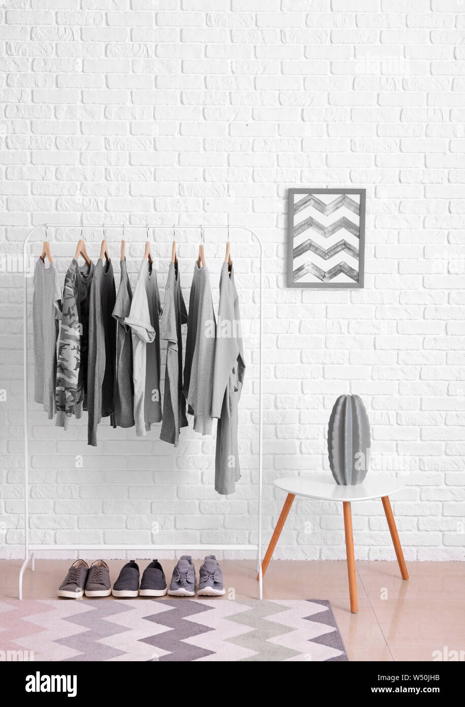 Rack with hanging clothes in interior of dressing room Stock Photo Alamy