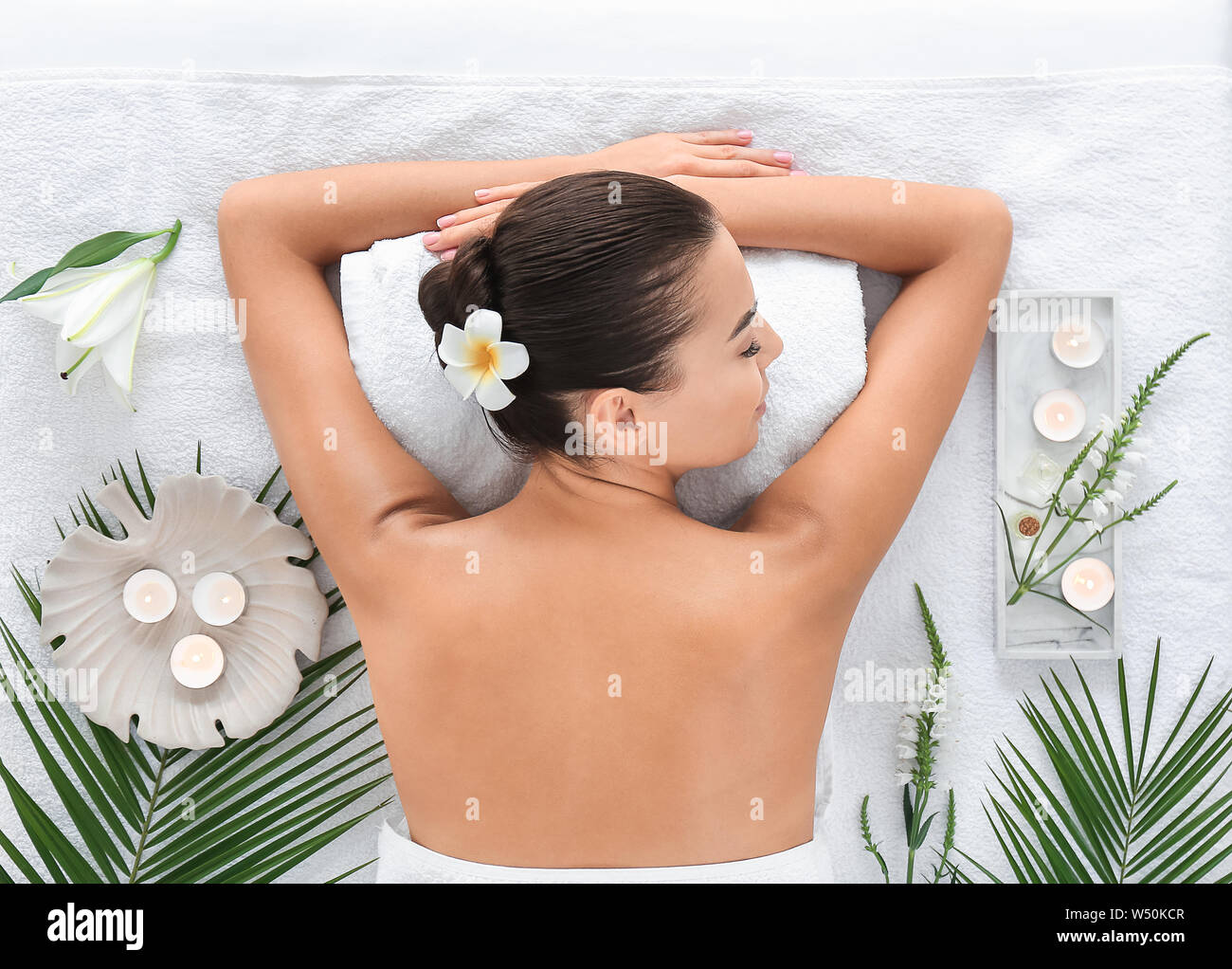 Beautiful young woman relaxing in spa salon Stock Photo - Alamy