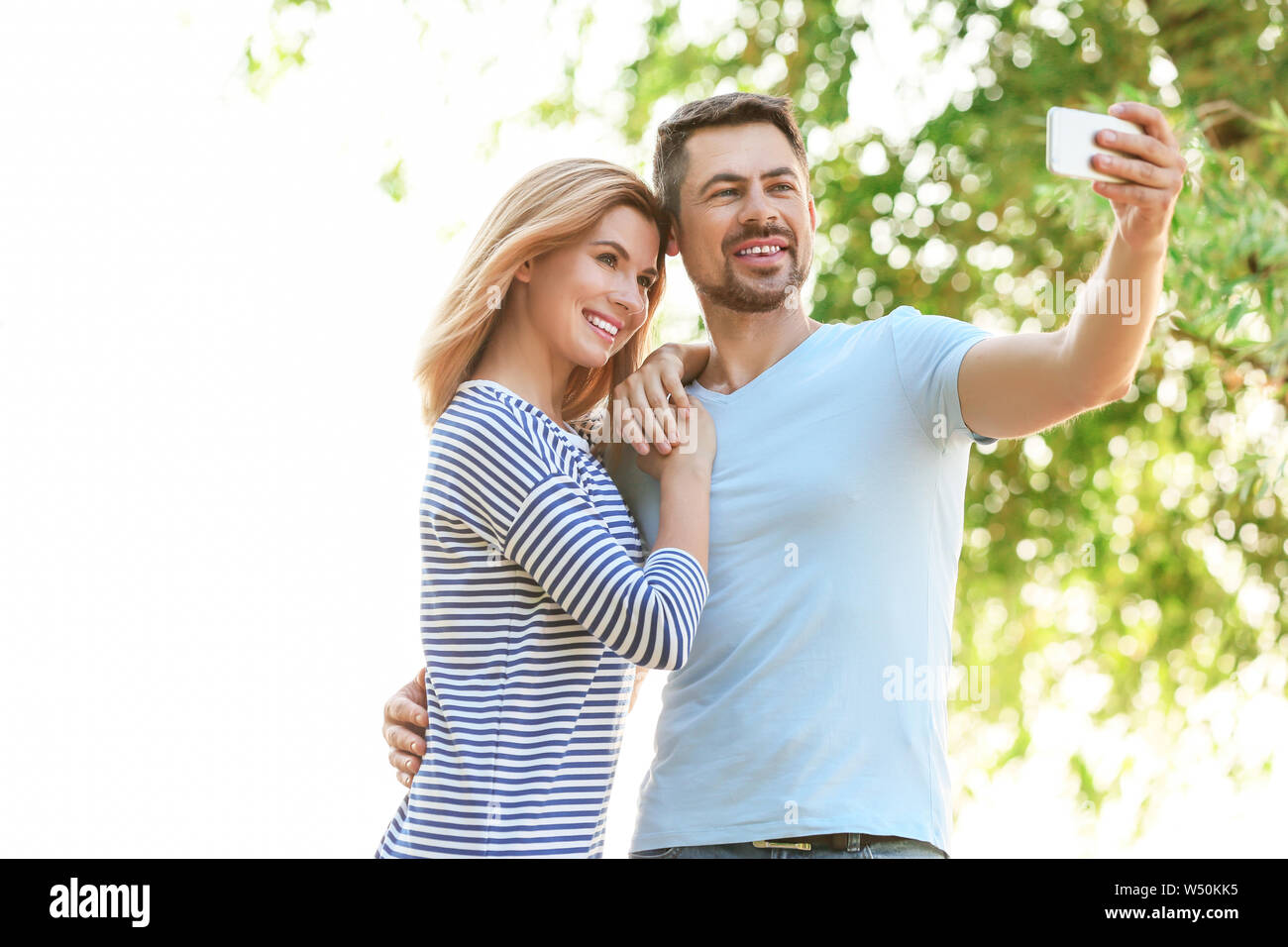 Happy couple in love taking selfie outdoors Stock Photo - Alamy
