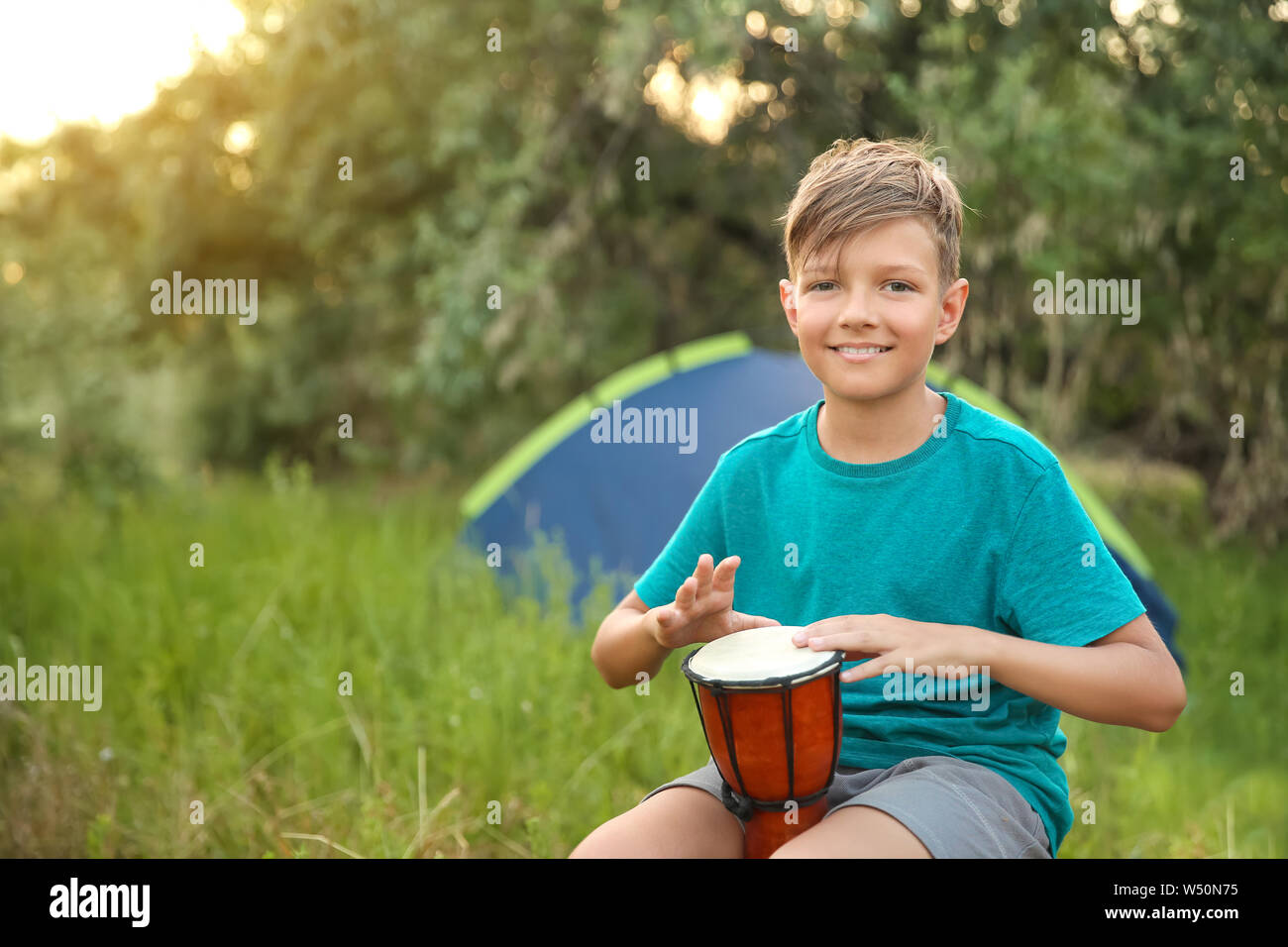 Little boy playing drum at summer camp Stock Photo Alamy