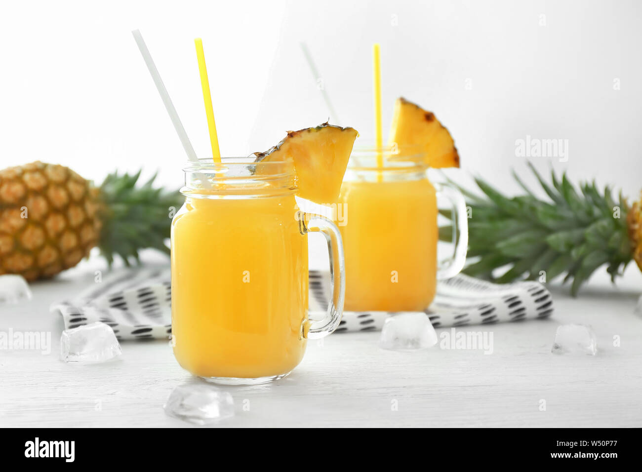 Mason jar of tasty pineapple juice on white table Stock Photo Alamy