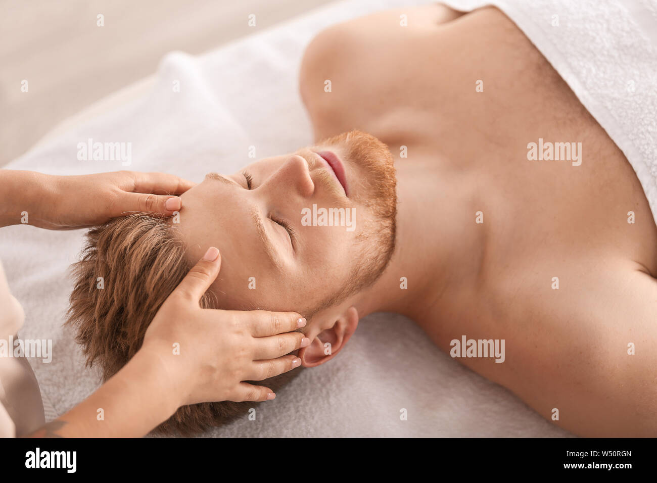 Premium Photo  Young man having neck and shoulders massage in a spa salon