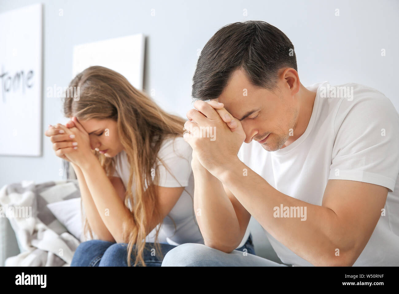 Religious couple praying to God at home Stock Photo Alamy