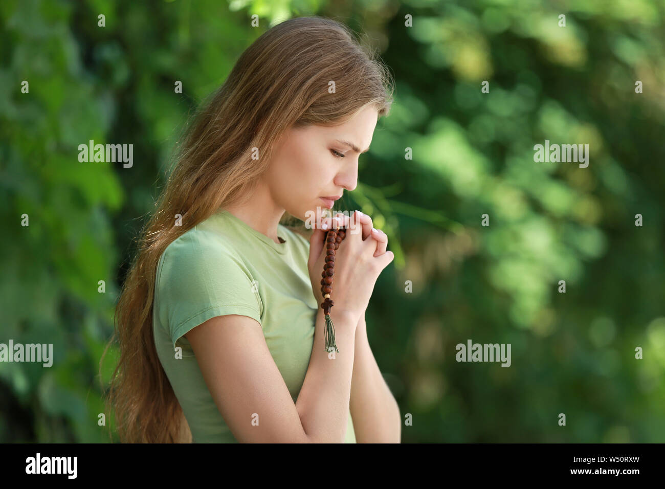Religious woman praying to God outdoors Stock Photo Alamy
