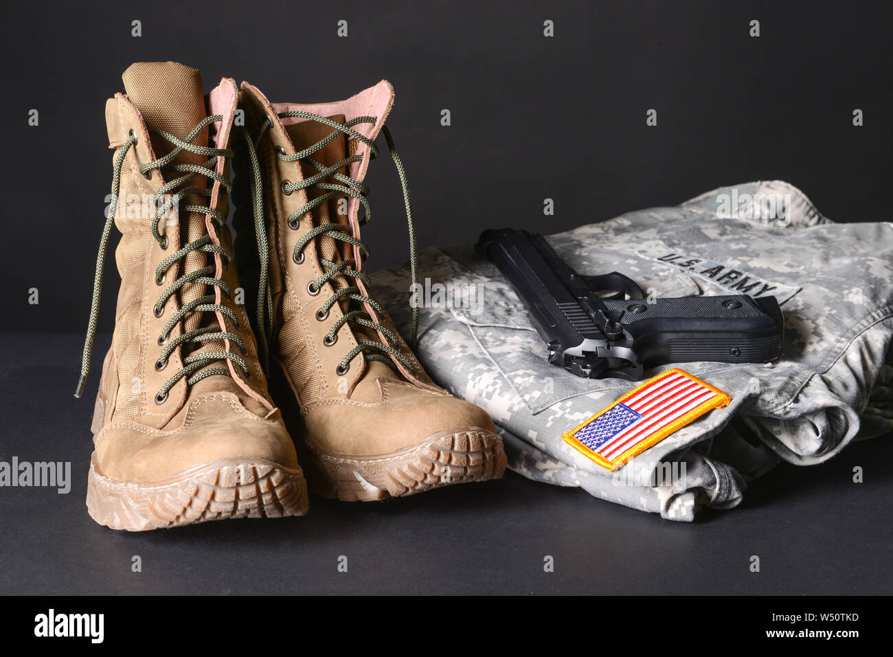 Military boots, uniform and gun on dark background Stock Photo Alamy