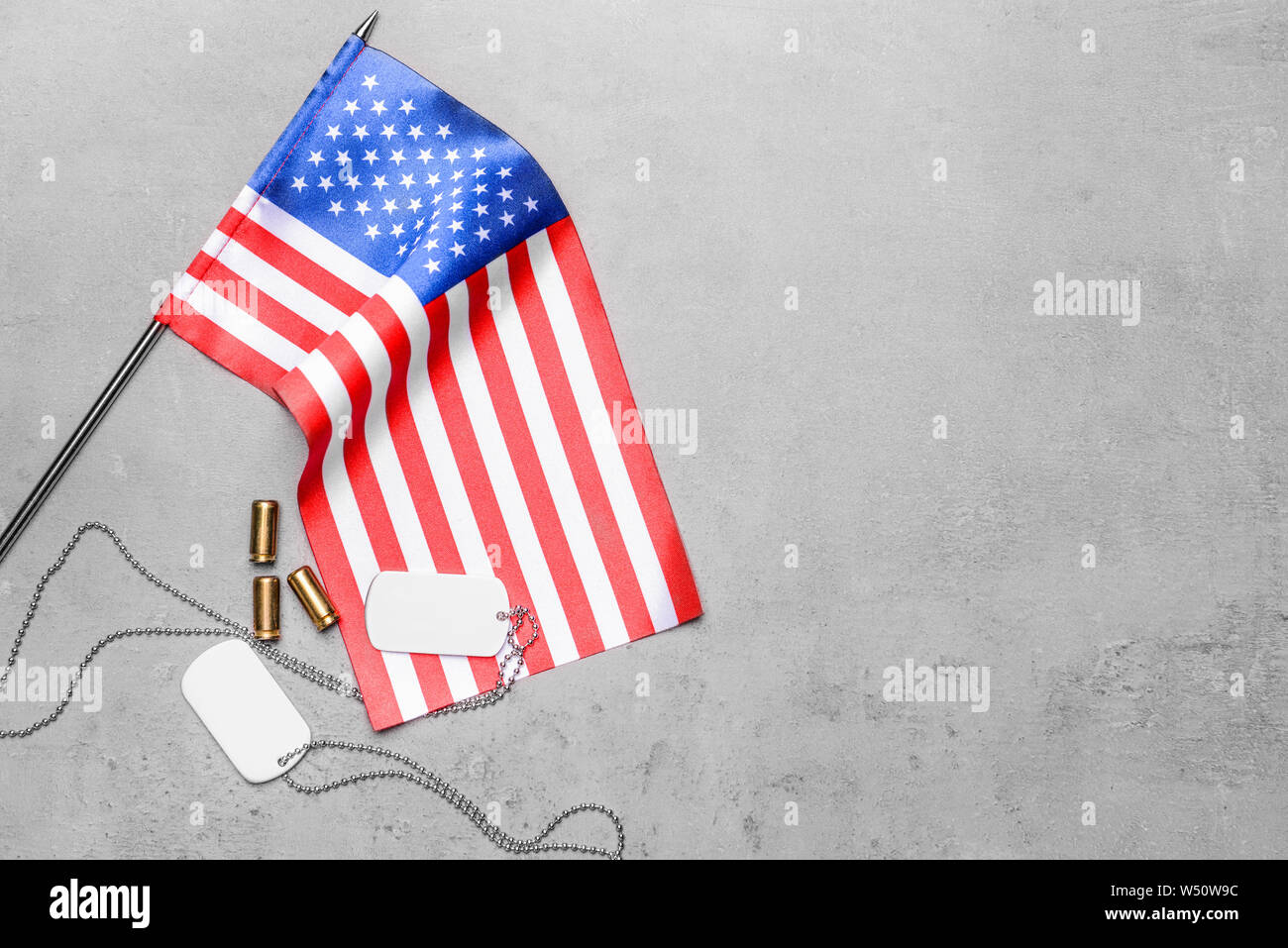 USA flag and military dog tags on grey background Stock Photo - Alamy