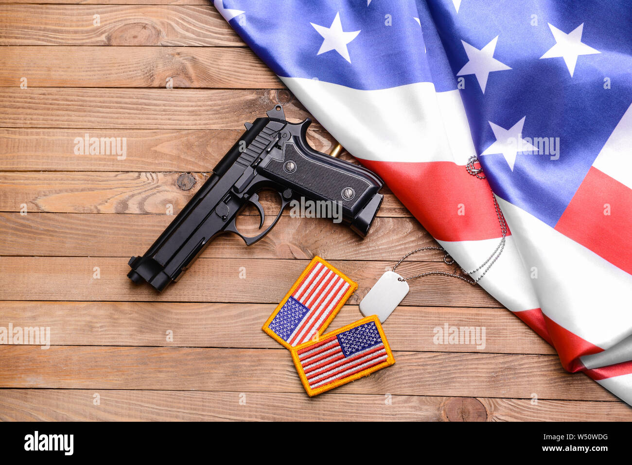 Gun military dog tag chevrons and USA flag on wooden background Stock Photo Alamy