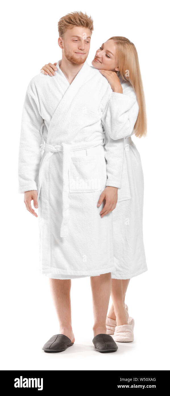 Happy young couple in bathrobes on white background Stock Photo Alamy
