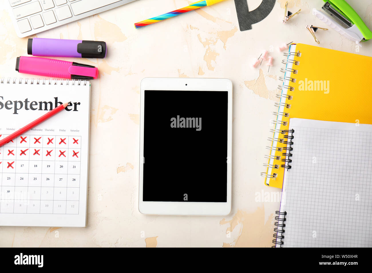 Modern tablet computer and stationery on light background Stock Photo