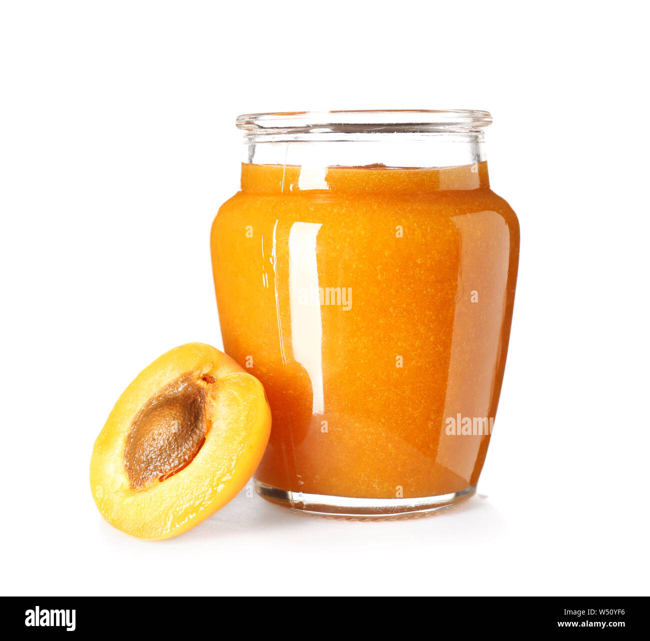 Glass jar of tasty apricot jam on white background Stock Photo - Alamy