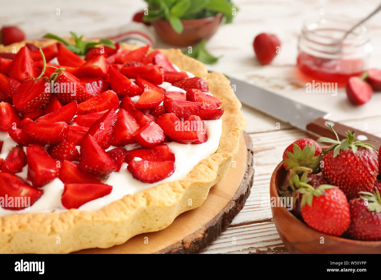 Tasty strawberry cake on white wooden table Stock Photo - Alamy