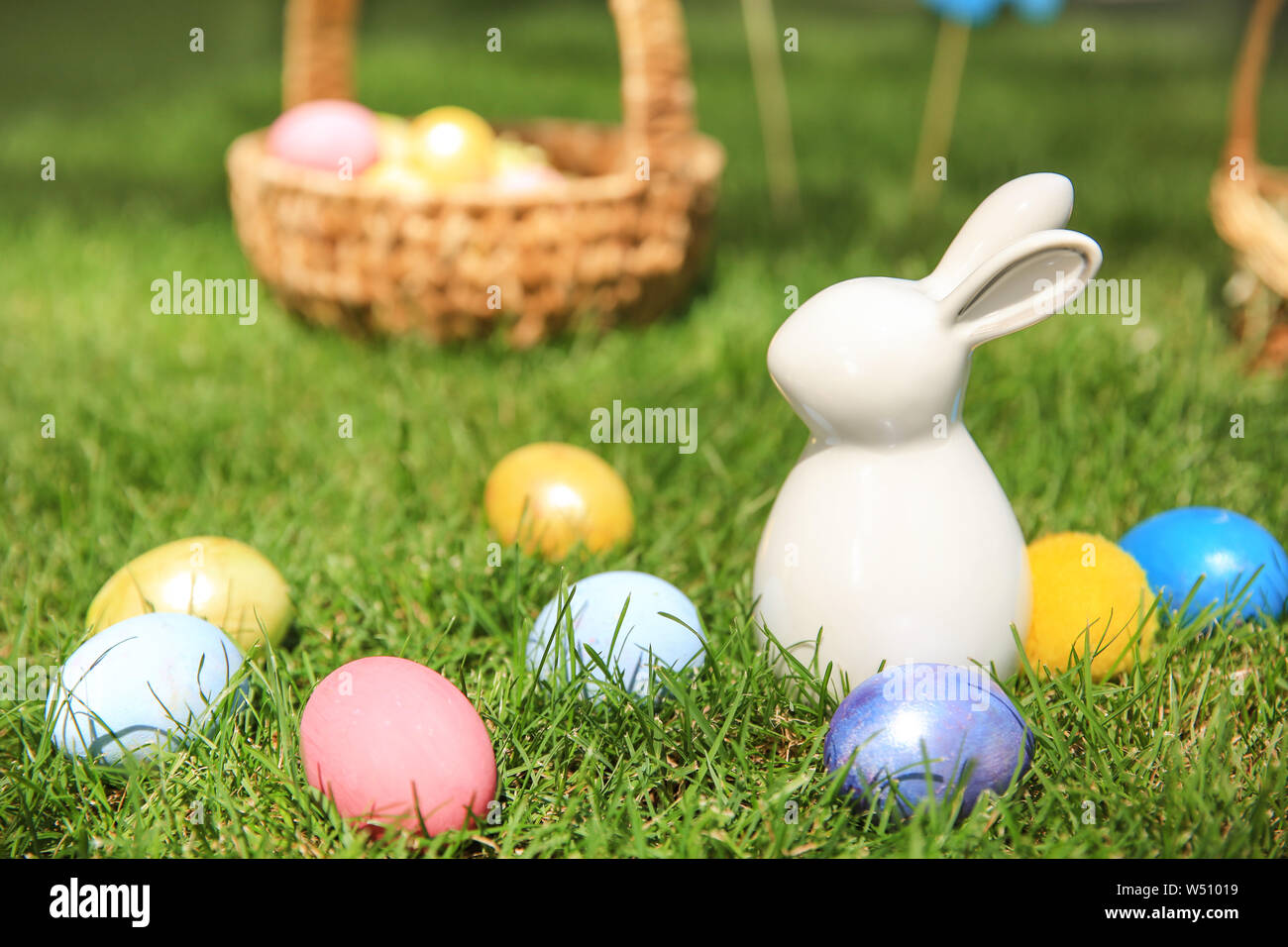 Easter eggs with ceramic bunny on grass outdoors Stock Photo - Alamy