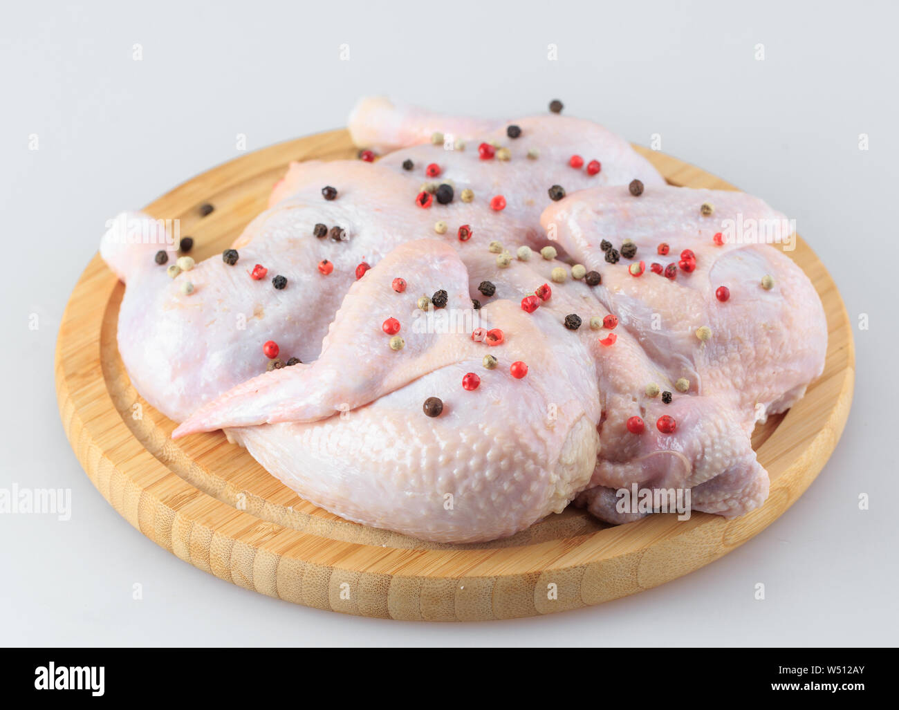 Raw chicken carcass on the cutting board isolated on white background