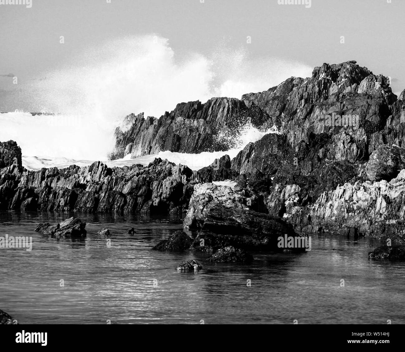 Majestic black and white scene of waves crashing against rocks Stock ...