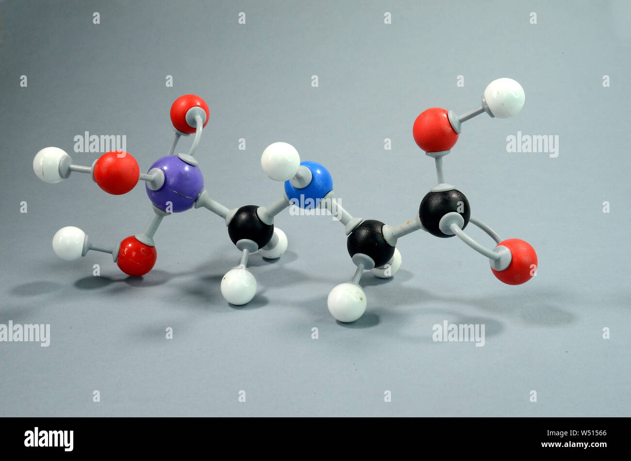 Molecule Model of Glyphosphate, a common pesticid. Black is Carbon, Red is Oxygen, white is Hydrogen, Blue is Nirogen, and violet is Phosphorous. Stock Photo