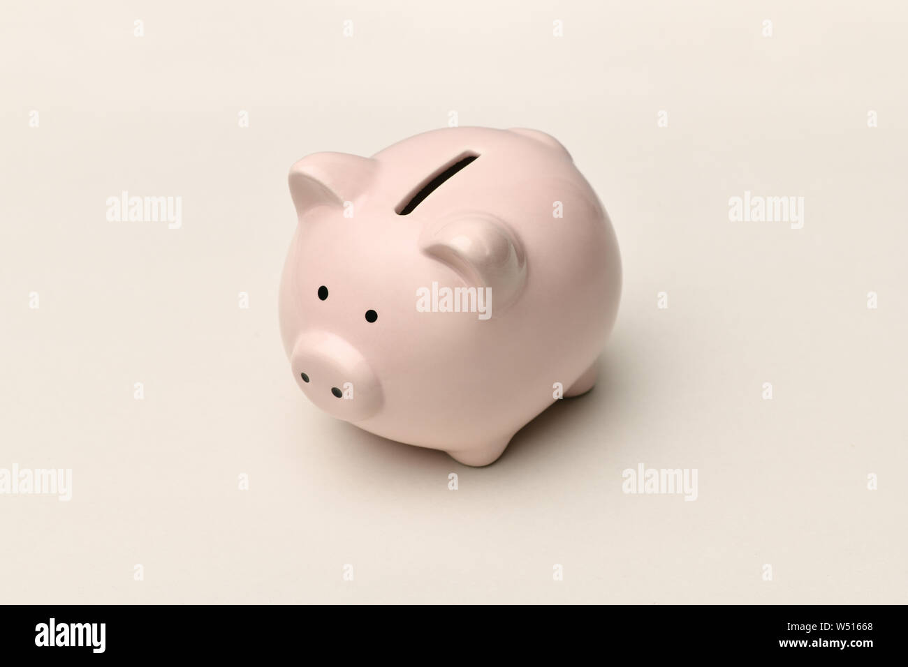 Pink piggy Bank stands on a gray background with a shadow. Horizontal photography Stock Photo