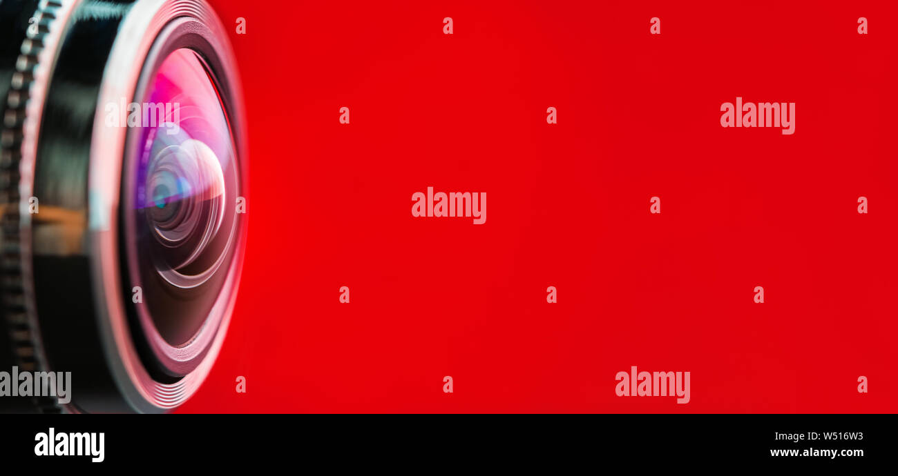 Banner. Camera lens with red backlight. Side view of the lens of camera on  red background. Red camera Lens close Up. Optics Stock Photo - Alamy