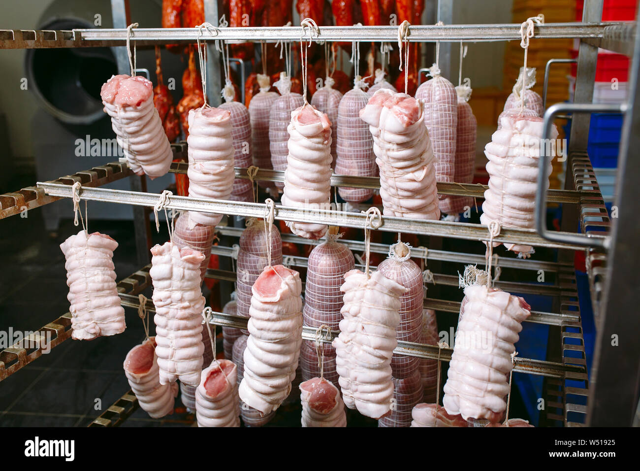 Smoked ham in the oven. Sausage production in the factory Stock Photo