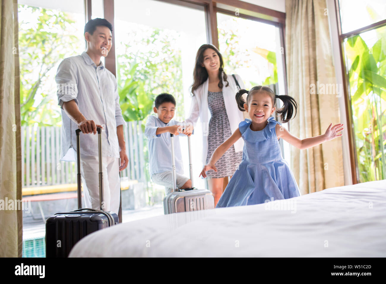 Happy young family in hotel room Stock Photo Alamy