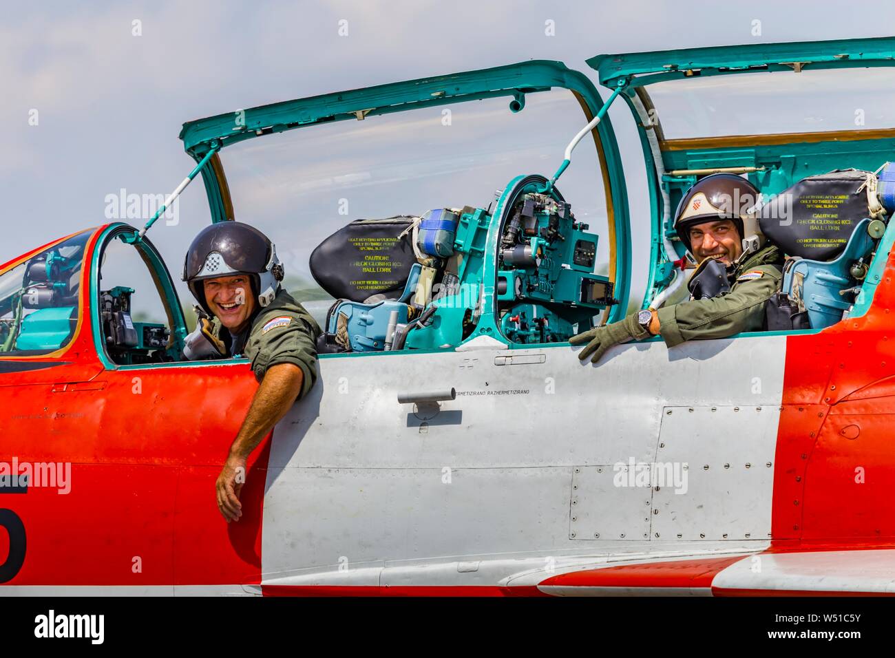 MiG-21 UM Kockica both crew-members looking out of cockpit into to camera smiling smile happy after flight landing Stock Photo