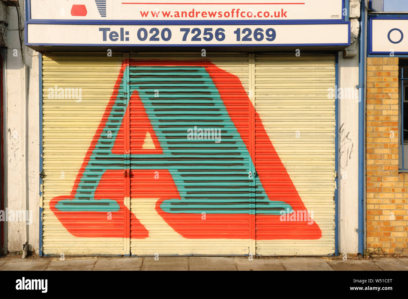Street Art, by Street Artist 'Eine', who paints gaint letters on shop window shutters, Hackney Road, London, Britain. Stock Photo
