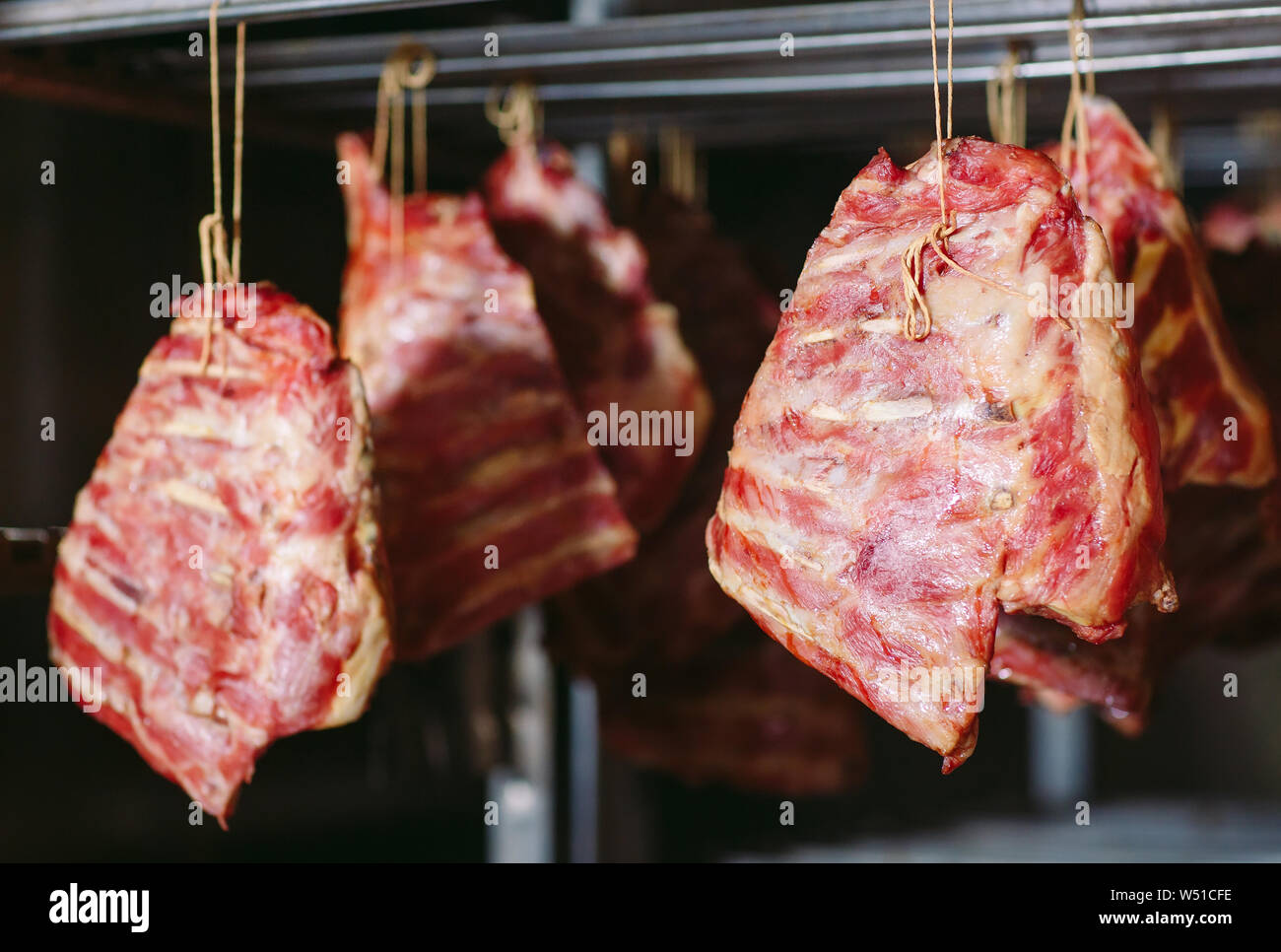smoking meat in the smokehouse in a meat factory Stock Photo Alamy
