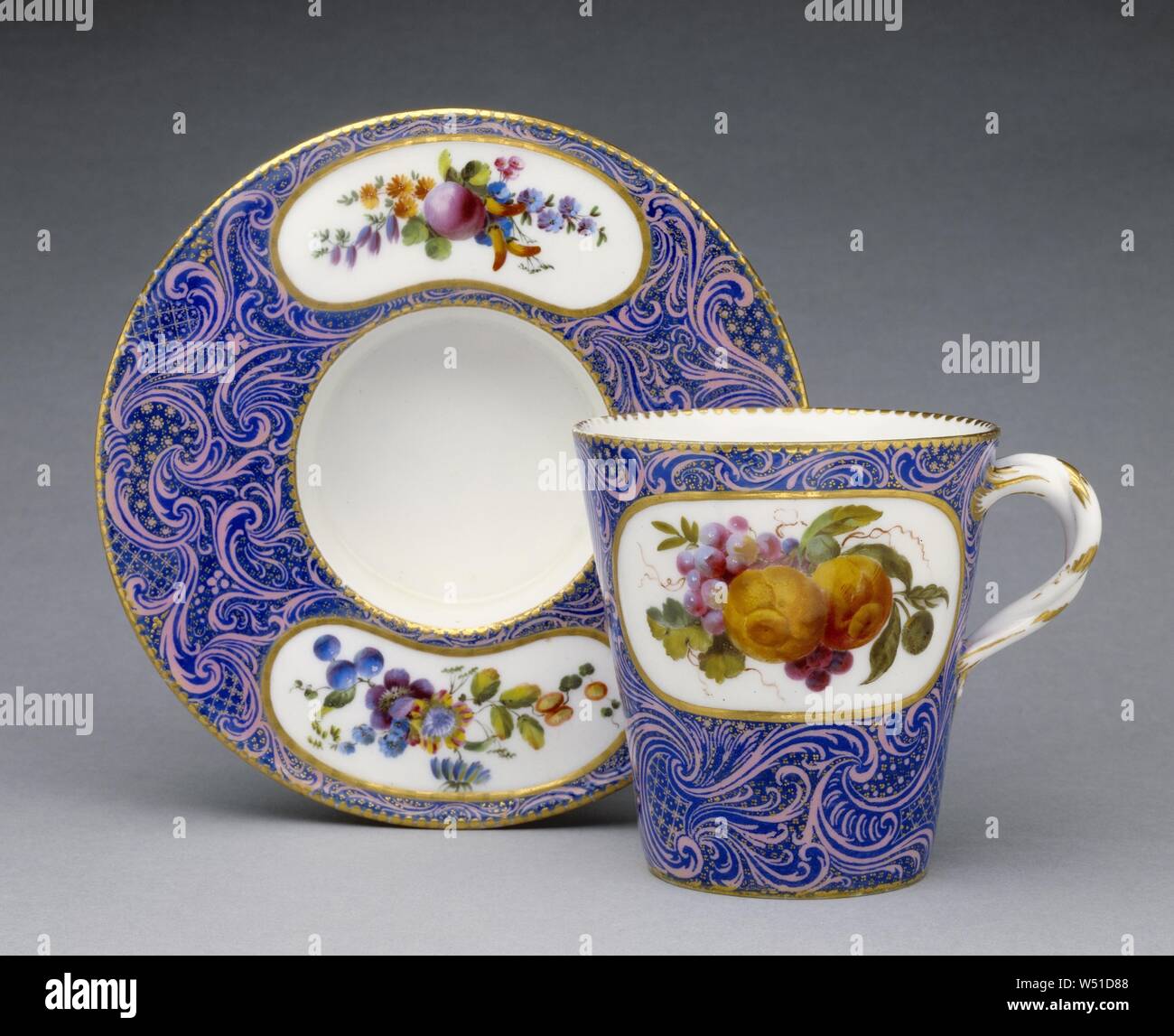 Cup and Saucer, Sèvres Manufactory (French, 1756 - present), 1761, Soft-paste porcelain, pink ground color overlaid with blue enamel, colored enamel decoration and gilding, 9 x 10.6 x 8.6 cm (3 9/16 x 4 3/16 x 3 3/8 in Stock Photo