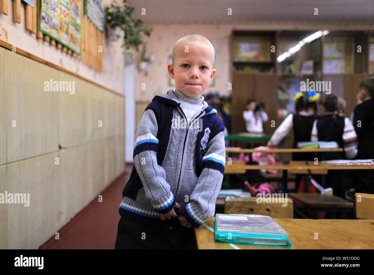 A cancer sick schoolboy which lives near the Chernobyl Exclusion Zone in his classroom during a school break. Radinka, Kiev Oblast, northern Ukraine Stock Photo