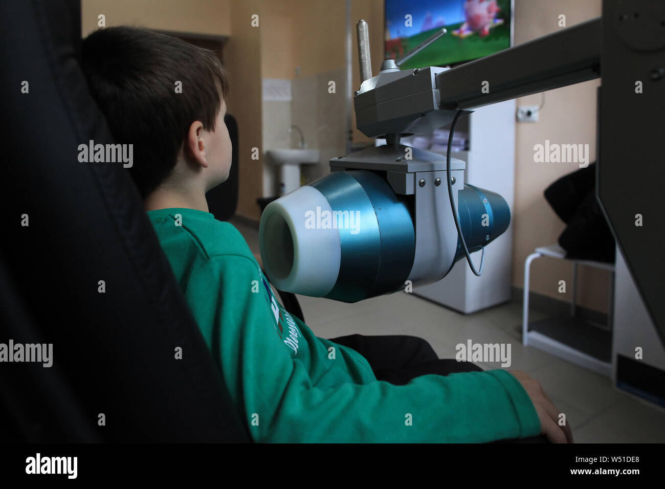 A boy living near the Chernobyl Exclusion Zone is checked with the spectrophotometer for internal contamination in the hospital in Ivankov. Ukraine Stock Photo
