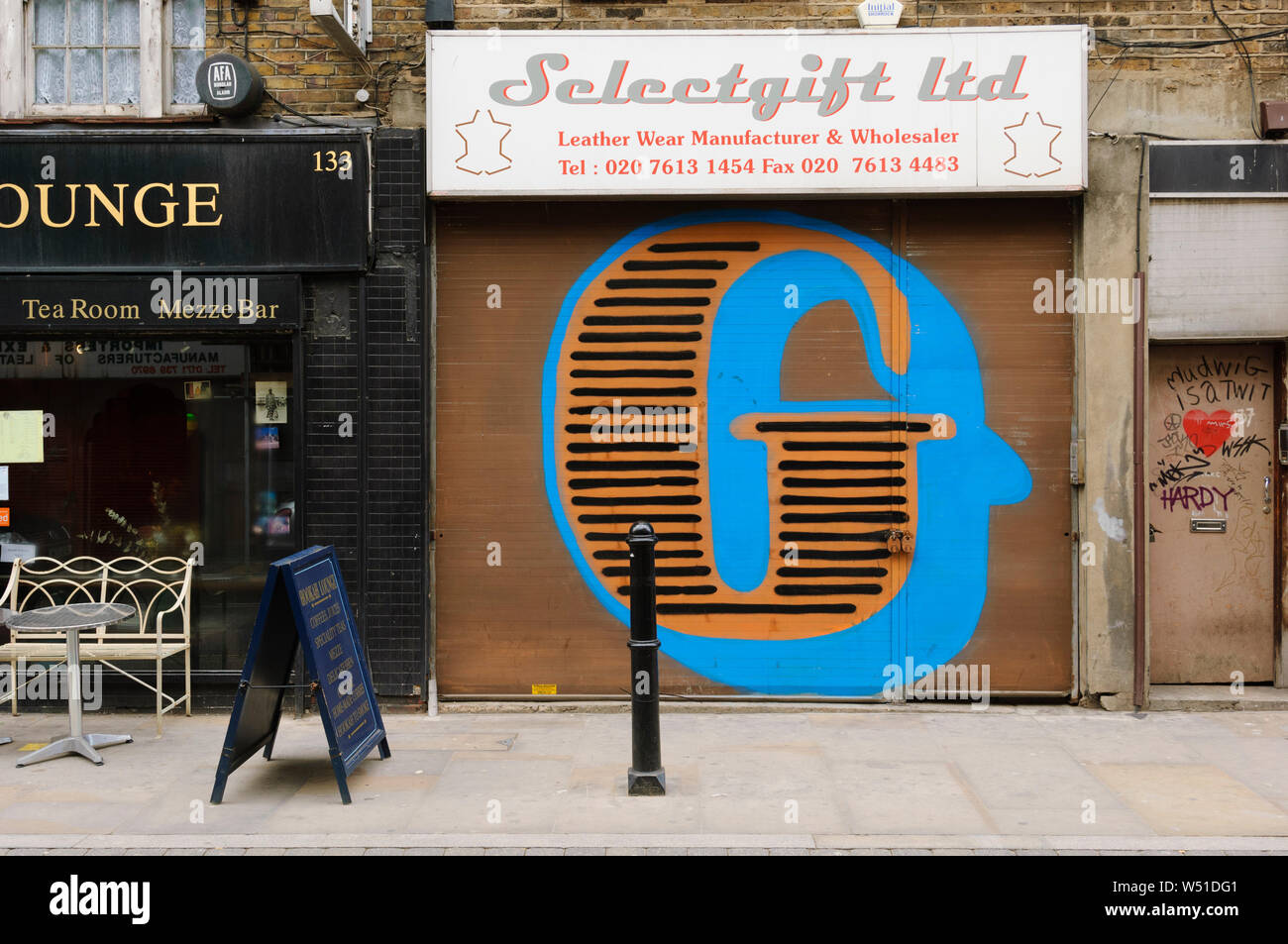 Street Art, by Street Artist 'Eine', who paints gaint letters on shop window shutters, Brick Lane, London, E1, Britain. Stock Photo