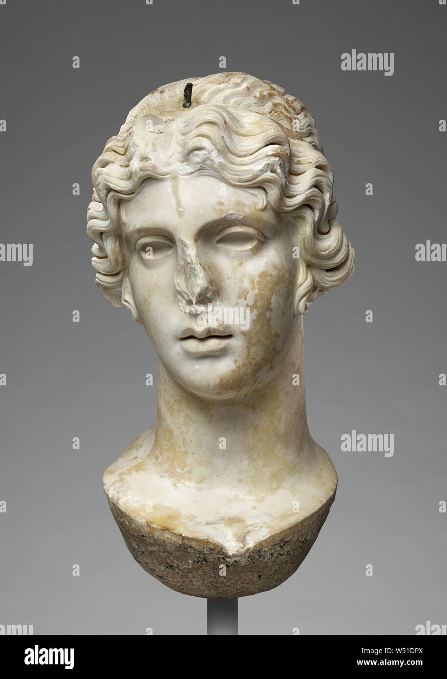 Colossal Head of a Divinity (made for insertion into statue), Unknown, Europe (?), 17th century, Carrara? marble, white, with traces of original paint around the eyes, also a hole for pin of bronze attachment, 52.1 × 26 × 26 cm (20 1/2 × 10 1/4 × 10 1/4 in Stock Photo