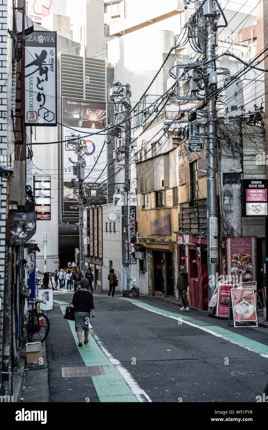 Street scene, small street with shops, chaotic power cables and Japanese signs, Shibuya, Tokyo, Japan Stock Photo