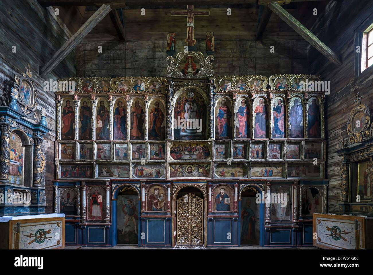 Orthodox sanctuary painted with iconostases, Gothic wooden church of St. Paraskevi from the 16th century, Radruz, Poland Stock Photo