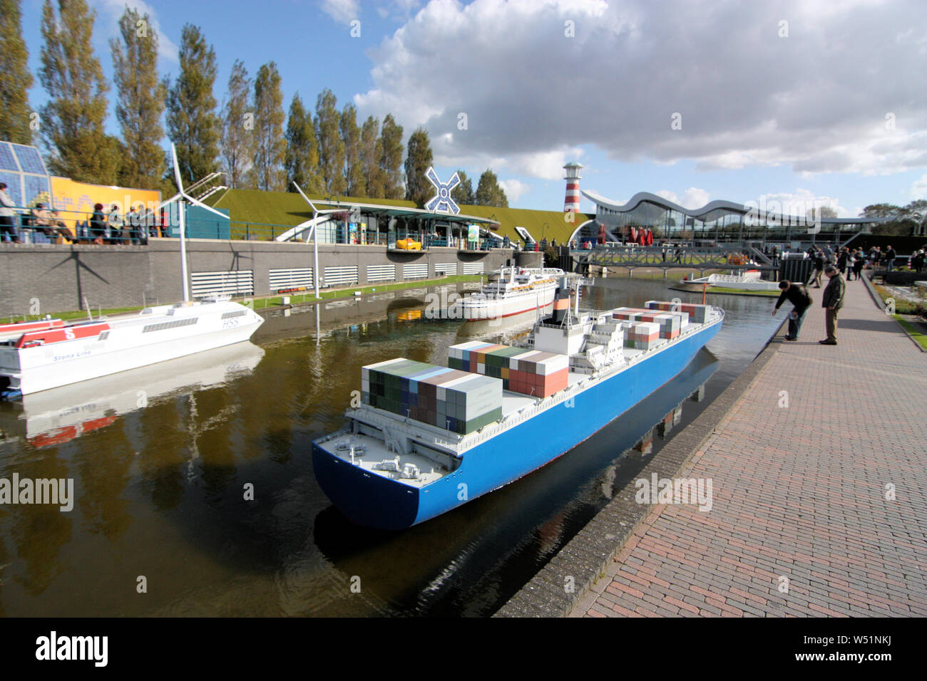 People are visiting Madurodam Miniature City in Scheveningen District in Den Haag where they can see the replicas of The Netherlands Cargo Ships. Stock Photo