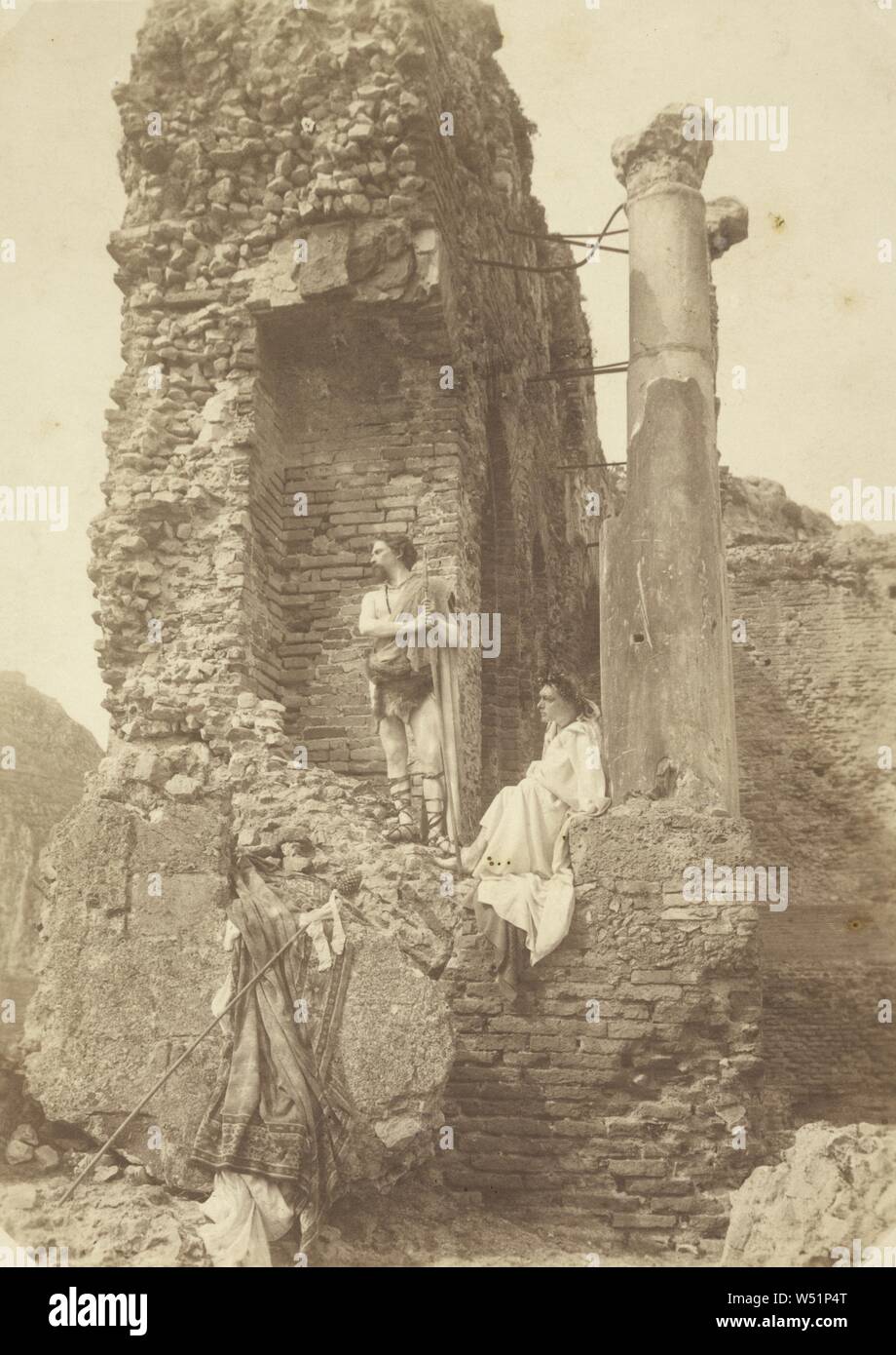 Two Men in costume near ruins, Baron Wilhelm von Gloeden (German, 1856 - 1931), Taormina, Sicily, Italy, 1903, Albumen silver print, 21.5 x 15.3 cm (8 7/16 x 6 in Stock Photo