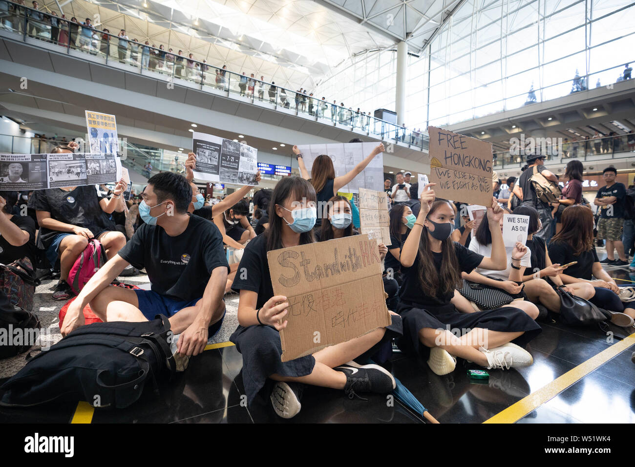 Demonstrators holding placards during the sit in protest at the airport ...
